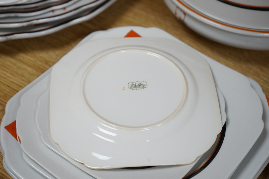 A Shelley ‘Vogue’ orange comprehensive dinner service. Largest platter 44cm wide. Condition - some enamelling worn or missing